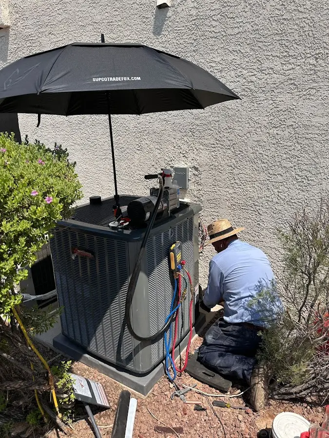 HVAC technician performing outdoor AC maintenance in Belton